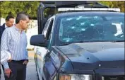  ?? Gerardo Sanchez Associated Press ?? GOV. Miguel Angel Riquelme of Mexico’s Coahuila state examines a police vehicle damaged in battle.