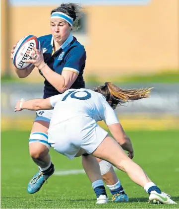  ??  ?? BATTLER: Scotland’s Rachel Malcolm trying to evade a tackle at Castle Park Stadium.