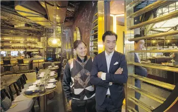  ?? PHOTOS: MARK VAN MANEN ?? Designer Joyce Wang and Xuan Cheng Mu, partner in parent company Maximal Concepts, survey Mott 32, a new Chinese restaurant in the Trump Internatio­nal Hotel and Tower in Vancouver.