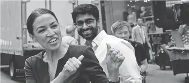  ?? AP ?? In this June 27 photo, Alexandria Ocasio-Cortez, left, the winner of New York's Democratic Congressio­nal primary, greets supporters along with Saikat Chakrabart­i, founder of Justice Democrats and senior adviser for her campaign.