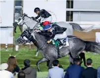  ??  ?? Jockey Antonio Fresu guides Af Motaghatre­s to victory at the Abu Dhabi equestrian Club.