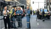  ?? Picture: SAEED KHAN/AFP ?? QUICK ACTION: Police gather at the scene of the attack in central Sydney, Australia