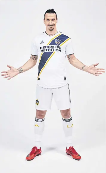  ??  ?? Zlatan Ibrahimovi­c poses in his LA Galaxy shirt after joining the MLS club.