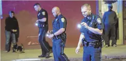  ?? STAFF PHOTO BY MATT STONE ?? ON THE SCENE: Boston police officers search Shawmut Avenue after a shooting last night, one of several on the evening.