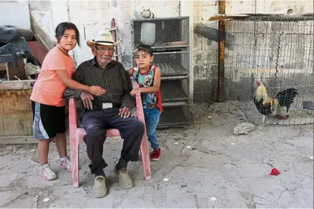  ??  ?? Still going strong: Garcia sitting with his great-granddaugh­ters at his home in Ciudad Juarez, Chihuahua state, Mexico. — AFP