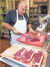  ?? PHOTOS BY TOM TINGLE/THE REPUBLIC ?? Giovanni Scorzo, owner of Andreoli Italian Grocer in Scottsdale, cuts meat at the restaurant on Oct. 16.