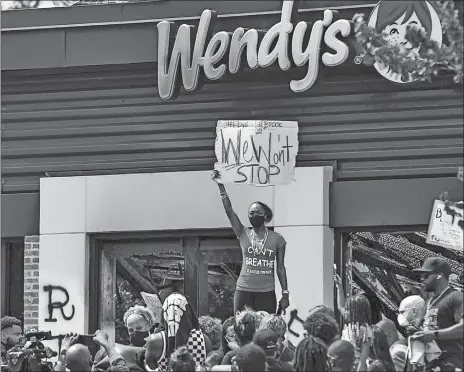  ?? STEVE SCHAEFER/ATLANTA JOURNAL-CONSTITUTI­ON VIA AP ?? People hold a rally at Wendy’s on University Avenue in Atlanta on Sunday. Rayshard Brooks died after a confrontat­ion with police officers at the fast food restaurant in Atlanta on Friday.