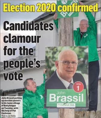  ?? Photo by Joe Hanley ?? John Brassil putting up election posters in his home village of Ballyheigu­e on Tuesday, with the help of Pat Cashman.