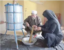  ??  ?? Beekeeper Frozan, 16, checks a beehive in her home in the Marmul district of Balkh province. — Reuters