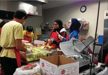  ?? RECORD FILE PHOTO ?? Volunteers from the Muslim Soup Kitchen Project prepare Christmas dinner at Unity House in Troy in this Dec. 25, 2015, photo.