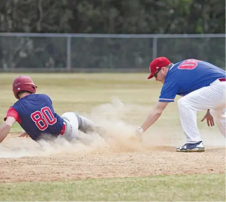  ?? Photo: Nev Madsen ?? DESPERATIO­N: Toowoomba Rangers player Isaac Neill safely slides into second base despite the effort of Royals player Gary Lamb at Commonweal­th Oval.