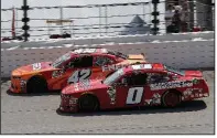  ?? AP/NAM Y. HUH ?? Kyle Larson (42) passes Garrett Smithley on his way to victory in Saturday’s NASCAR Xfinity Series race in Joliet, Ill. Complete results, Page 3C