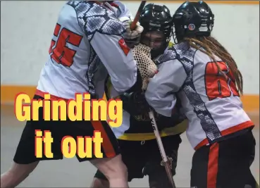  ?? NEWS PHOTO RYAN MCCRACKEN ?? Tanner Dynes of the Medicine Hat Sun Devils withstands a pair of body checks from Paul Block (left) and Nicholas Torrez (right) during Sunday’s Rocky Mountain Lacrosse League Tier 2 junior B matchup at the Moose Recreation Centre.