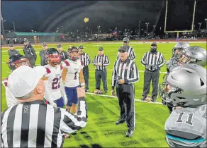  ?? Southern Nevada Officials Associatio­n ?? Referee John Hathaway, center, heads an officiatin­g and operations crew of current and former military members for the Silveradoc­oronado Class 4A state semifinal football game on Veterans Day.