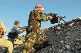  ?? Marc-Antoine Pelaez / AFP / Getty Images ?? Peshmerga fighters take aim from their position at the Altun Kupri checkpoint, 25 miles from Kirkuk, on Friday. Iraqi forces clashed with Kurdish fighters.