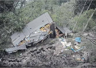  ?? CARL COURT GETTY IMAGES ?? A house lies in ruins Friday after being hit by a landslide caused by an earthquake in Atsuma, Japan.