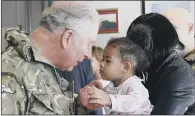  ?? PICTURES: PA WIRE. ?? ‘FANTASTIC EXPERIENCE’: Top, The Prince presents campaign medals to the soldiers; above, Starr Mitchell, two, and mother Lisa Mitchell, the family of Guarsdman Craig Mitchell.