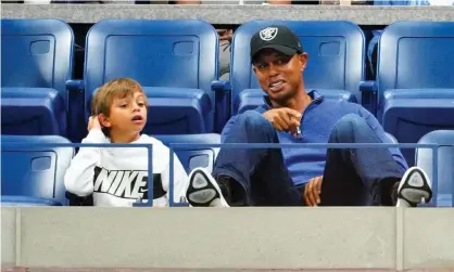  ??  ?? Tiger Woods and his son Charlie watch the US tennis Open in 2019. Photograph: Gotham/GC Images