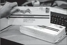  ?? [MATT ROURKE/ASSOCIATED PRESS FILE PHOTO] ?? Dave Turnier processes mail-in ballots May 28 at the Chester County Voter Services office in West Chester, Pa., prior to the primary election.