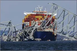  ?? JULIA NIKHINSON — THE ASSOCIATED PRESS ?? Wreckage of the Francis Scott Key Bridge rests on the container ship Dali on Saturday in Baltimore, Md. The Dali's crew members remain aboard the ship.