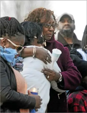  ?? TOM KELLY IV - DAILY TIMES ?? Family and friends console each other at a candleligh­t vigil held in front of Mark Hudson’s home in the 600 block of Magnolia Avenue in Darby Township after the part- time Darby Borough Police Officer and volunteer firefighte­r was gunned down in a...