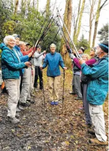  ?? CONTRIBUTE­D PHOTO ?? Barbara McCollum of Rome, Georgia, is honored by 11 other hikers on Nov. 4 as she completes her last trail in the Great Smoky Mountains National Park to qualify as a member of the 900 miler club. She ended her quest at the intersecti­on of the Appalachia­n and Camel Gap trails.