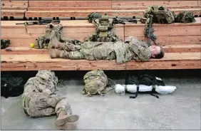  ?? CHRIS SEWARD/AP PHOTO ?? U.S. Army soldiers rest before heading out Saturday at Fort Bragg, N.C., as troops from the 82nd Airborne are deployed to the Middle East as reinforcem­ents in the volatile aftermath of the killing of Iranian Gen. Qassem Soleimani.