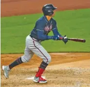  ?? AP PHOTO/KATHY WILLENS ?? The Atlanta Braves’ Ehire Adrianza watches his RBI sacrifice fly in the fifth inning against the Yankees on Wednesday.