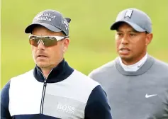  ?? — AFP photo ?? Henrik Stenson of Sweden and Tiger Woods walk down the 15th hole during the first round of the Valspar Championsh­ip at Innisbrook Resort Copperhead course in Palm Harbor, Florida.