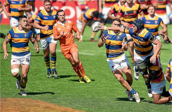  ?? GETTY IMAGES ?? Bay of Plenty’s Ben Blake gets a pass away to his support players despite being tackled during his side’s 36-32 win over Waikato in Tauranga yesterday.