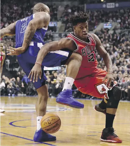  ?? FRANK GUNN/THE CANADIAN PRESS ?? Raptors forward P.J. Tucker’s defensive play helped make life tough for Chicago Bulls star Jimmy Butler during Toronto’s win on Tuesday night.