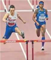  ?? — AP ?? Norway’s Karsten Warholm (left) en route to his men’s 400 metres hurdles gold at the World Athletics Championsh­ips in Doha on Monday.