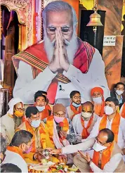  ?? — PTI ?? Madhya Pradesh Chief Minister Shivraj Singh Chouhan during a ceremony for the long life of Prime Minister Narendra Modi, at a temple in Bhopal on Thursday.