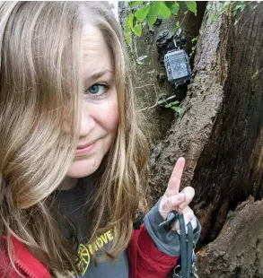  ?? SUBMITTED PHOTO ?? Laura Neale, who serves on the board of the Arkansas Geocachers Associatio­n, points to a cache she found. She said geocaching has introduced her to some cool spots in Arkansas that she normally wouldn’t have found.