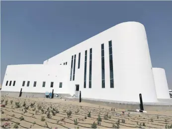  ?? Chris Whiteoak / The National ?? The largest 3D-printed two-storey structure in the world opened yesterday in Warsan, Dubai. Officials said constructi­on costs and the number of labourers were reduced by half, while the building cut waste by two thirds