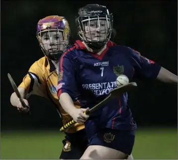  ??  ?? Presentati­on defender Fiona Kinsella shields the ball from Sarah Ní Fhionlainn.