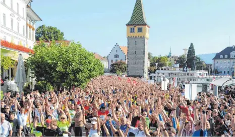  ?? FOTO: OLIVER LERCH ?? Am Sonntag, 8. Oktober, gehen beim Warm-up an der Inselprome­nade vor dem Start die Hände der Teilnehmer wieder in die Höhe.