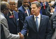  ?? BOB ANDRES / BANDRES@AJC.COM ?? “When (a measure) passes with a constituti­onal majority, it might not matter what I think,” said Gov. Brian Kemp, seen here in January being greeted by lawmakers.