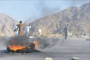  ??  ?? Men shout slogans against terrorists after a suicide attack Tuesday among the protesters in Nangarhar province, Afghanista­n.