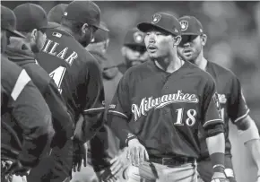  ?? ASSOCIATED PRESS ?? Keston Hiura celebrates with teammates Tuesday after getting two hits in his major-league debut against Philadelph­ia.