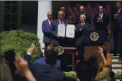  ?? EVAN VUCCI — THE ASSOCIATED PRESS FILE ?? President Donald Trump poses for a photo after signing the Paycheck Protection Program Flexibilit­y Act during a news conference in the Rose Garden of the White House.