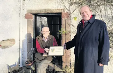  ??  ?? Presentati­on Sir William Macpherson of Cluny was presented with his honorary membership certificat­e by Blairgowri­e Golf Club captain James Macfarlane in January