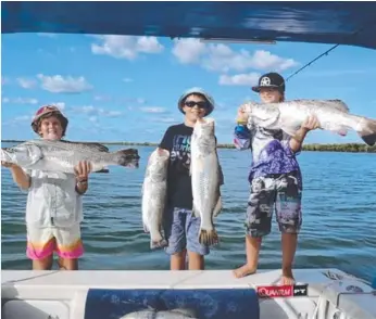  ??  ?? Beautiful barras: Jesse Hall, Darcy Bolton and Bodie Bell show off their impressive catch.