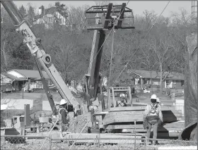  ?? NWA Democrat-Gazette/ANDY SHUPE ?? Nabholz Constructi­on employees work Friday at the site of a planned dormitory on the south end of Stadium Drive near Bud Walton Arena on the University of Arkansas campus in Fayettevil­le.