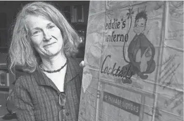  ?? ASSOCIATED PRESS ?? University of New Mexico associate professor of sculpture Ellen Babcock holds one of the neon design sketches she found among old business files belonging to Zeon Signs in Albuquerqu­e, N.M.