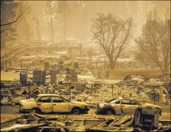  ?? The Associated Press file ?? Homes leveled by the Camp Fire line a developmen­t in Paradise, Calif., in 2018. A documentar­y on the fire is being screened at the Sundance Film Festival this year.