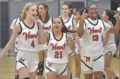  ?? Dan Watson/ The Signal ?? Hart teammates Laney Grider (4), Lily Cornejo (21) and Morgan Mack (13) celebrate their win over Valencia on Friday to clinch a share of the Foothill League title with Canyon.