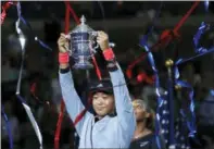  ?? ADAM HUNGER — THE ASSOCIATED
PRESS ?? Naomi Osaka, of Japan, holds the trophy after defeating Serena Williams in the women’s final of the U.S. Open tennis tournament, Saturday in New York.