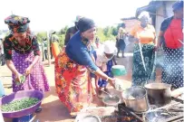  ?? ?? First Lady Dr Auxillia Mnangagwa leads women in preparing meals at Gogo Ellah Guta’s homestead in Mutasa, Manicaland yesterday