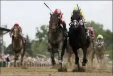  ?? MIKE STEWART — THE ASSOCIATED PRESS ?? Cloud Computing, second from left, ridden by Javier Castellano, wins the 142nd Preakness Stakes horse race ahead of Classic Empire, ridden by Julien Leparoux, Saturday at Pimlico Race Course in Baltimore.